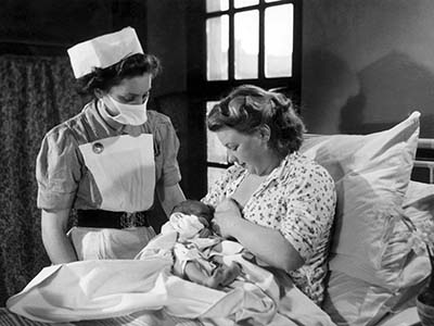 Midwife providing instructions on breastfeeding 300x400.jpg